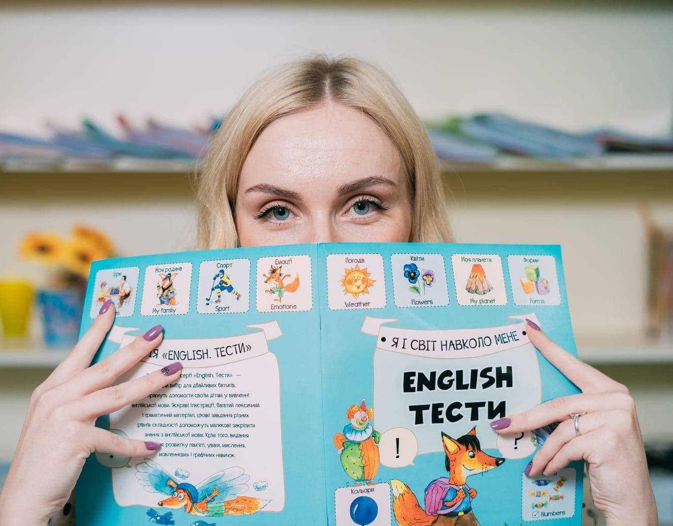 A woman holding an English-language exercise book