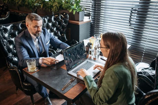 Two professionals reviewing a screen during a discussion