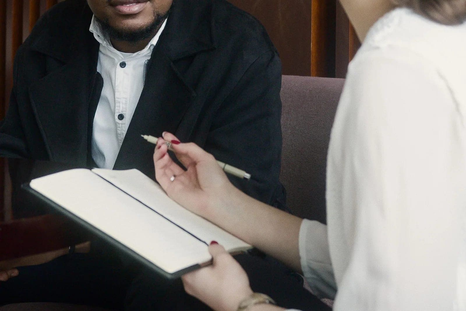 Professionals practicing a focused interview conversation