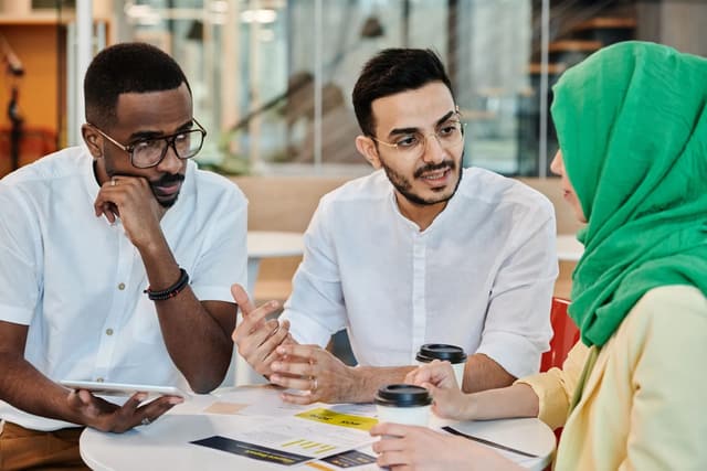 A diverse professional team having a candid workplace discussion