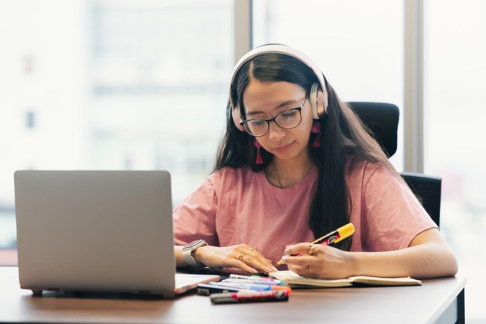 Focused Young Woman Studying with Laptop