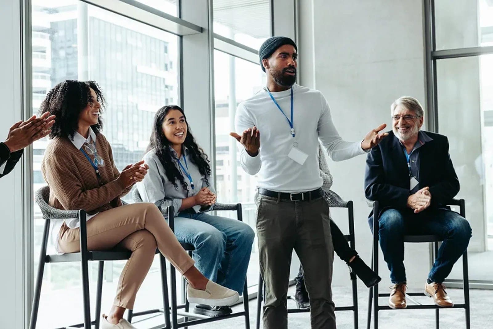 A man explaining an idea to a small group during a workplace session