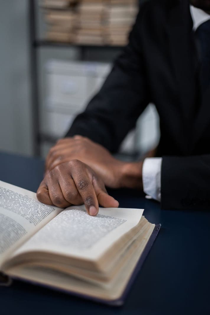Hands following the text in an open book