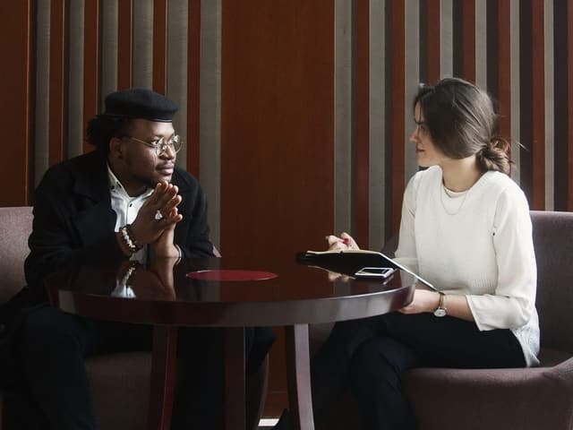 Two professionals talking across a small table