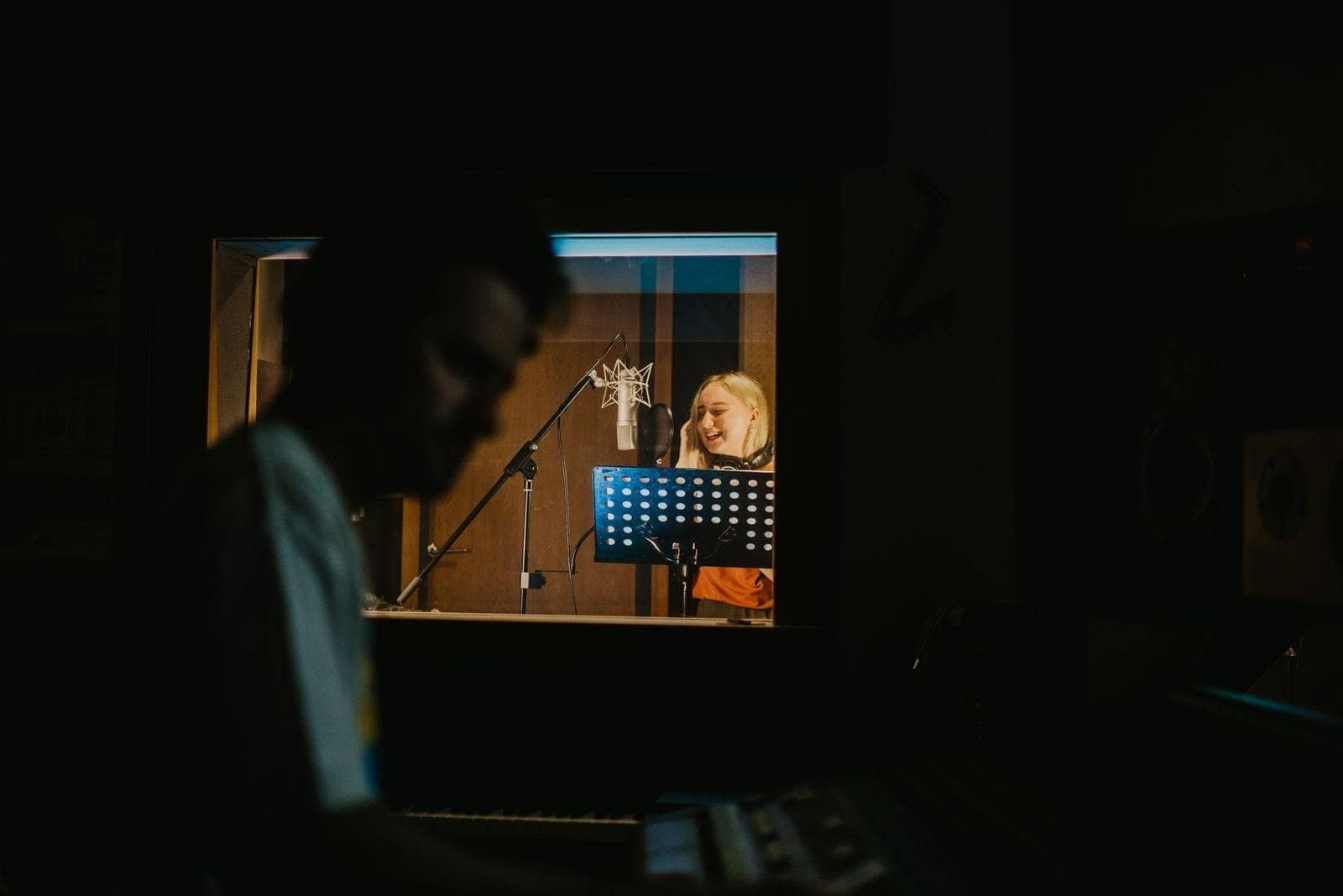 Woman Singing at a Recording Studio