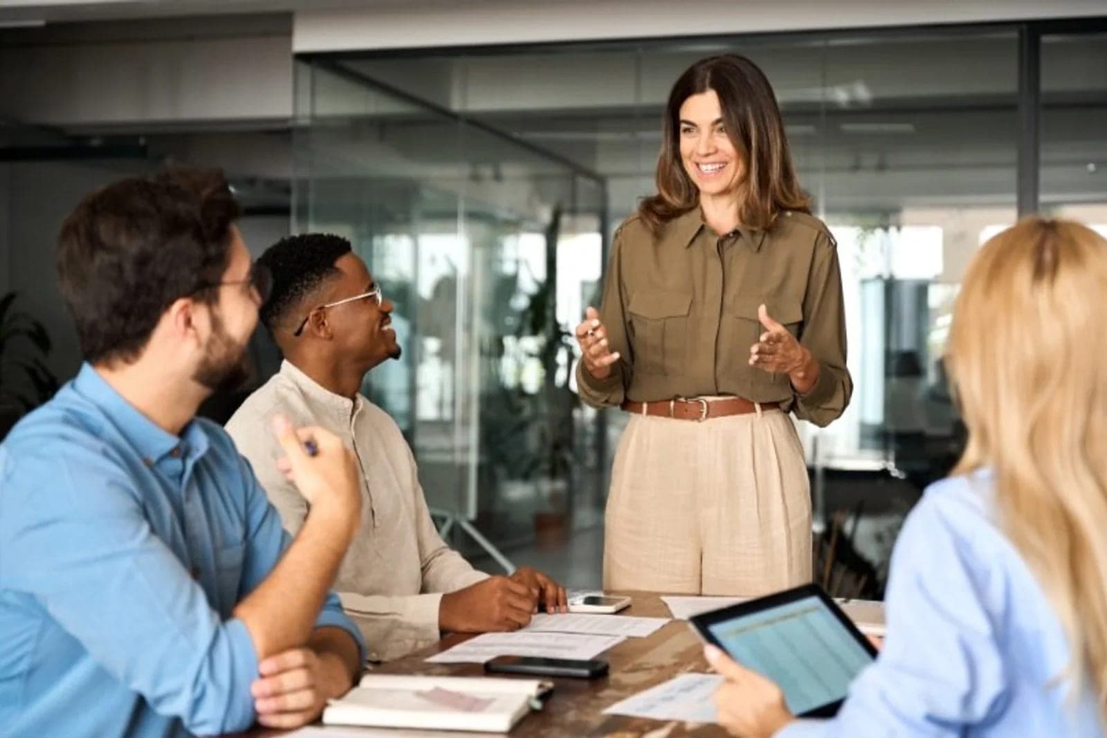 A leader speaking with colleagues during a focused team discussion
