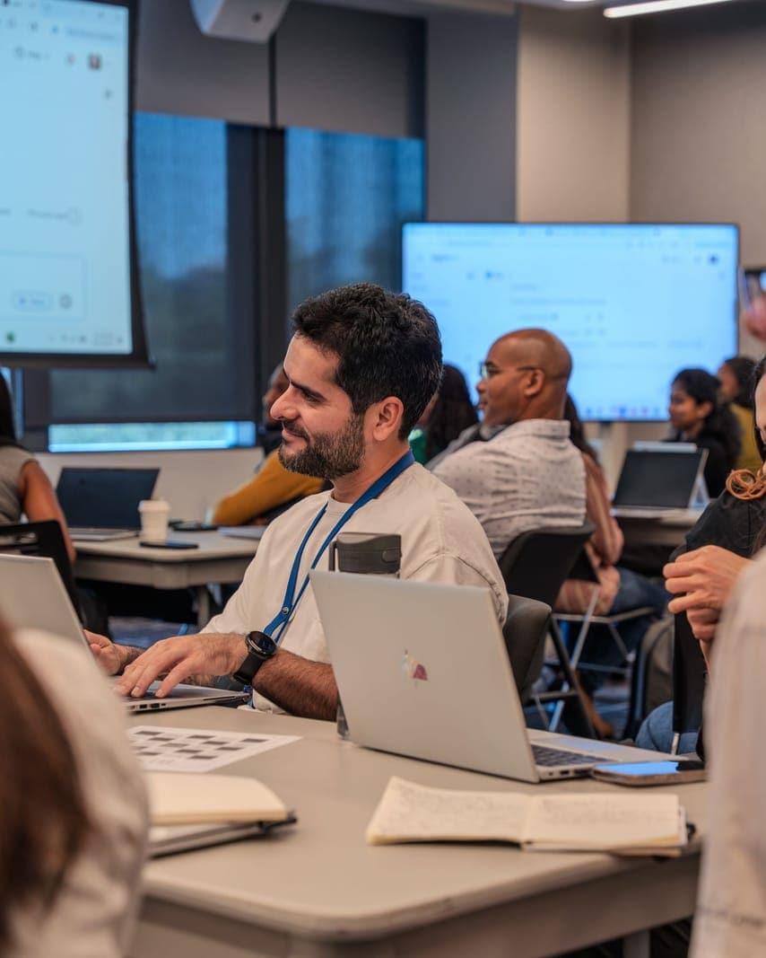 Workshop participants using laptops around a table