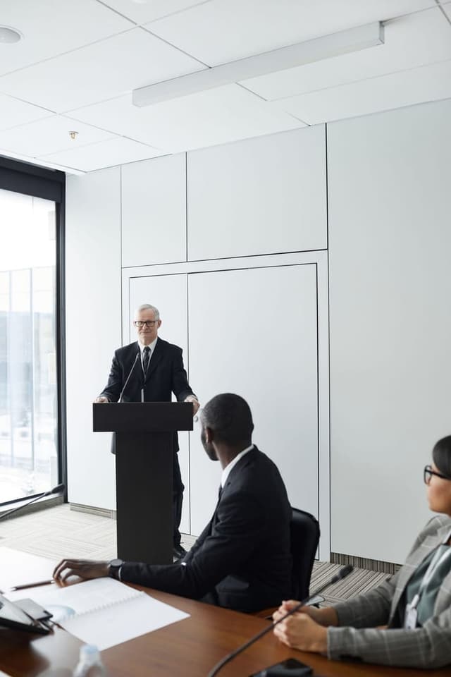 Professionals listening to a speaker at a lectern