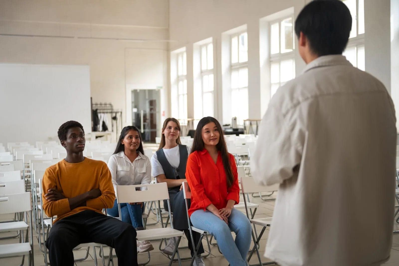 A diverse group listening during a professional speaking session