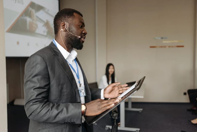 An international professional speaking with calm confidence in a boardroom