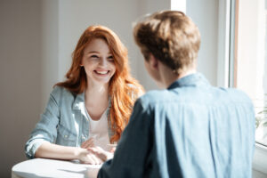 Professional speaking confidently with a colleague after completing accent reduction classes
