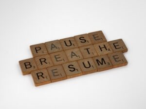 Scrabble letters that spell out pause, breathe, resume